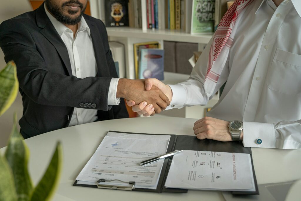 Two professionals shaking hands in an office
