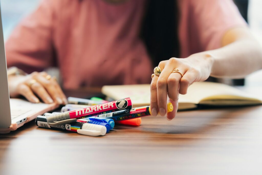 Close-up of a hand writing notes with a pen
