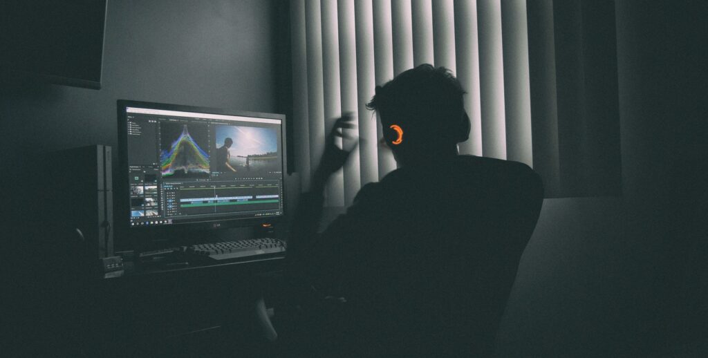 Silhouette of a professional looking stressed while working late at a laptop