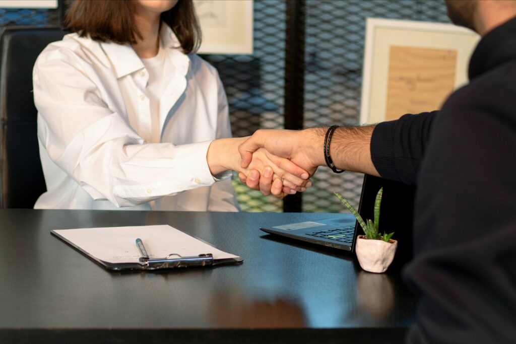 Man and woman shaking hands in a professional setting