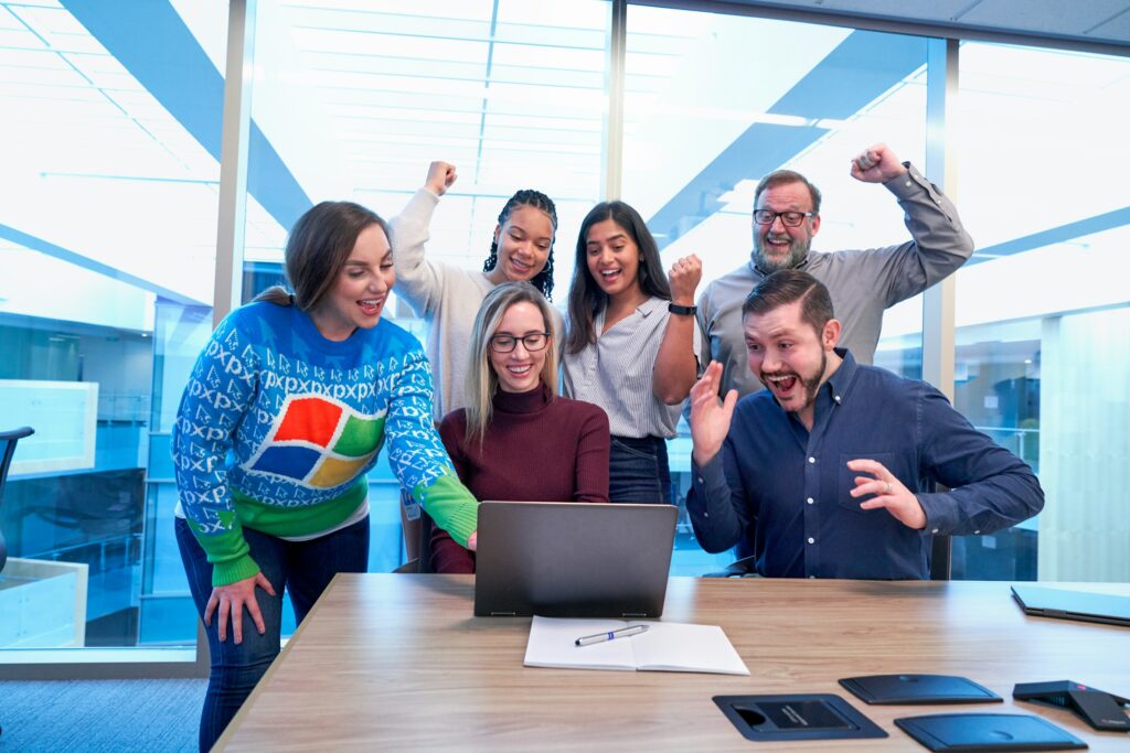 Group of colleagues celebrating with a high five